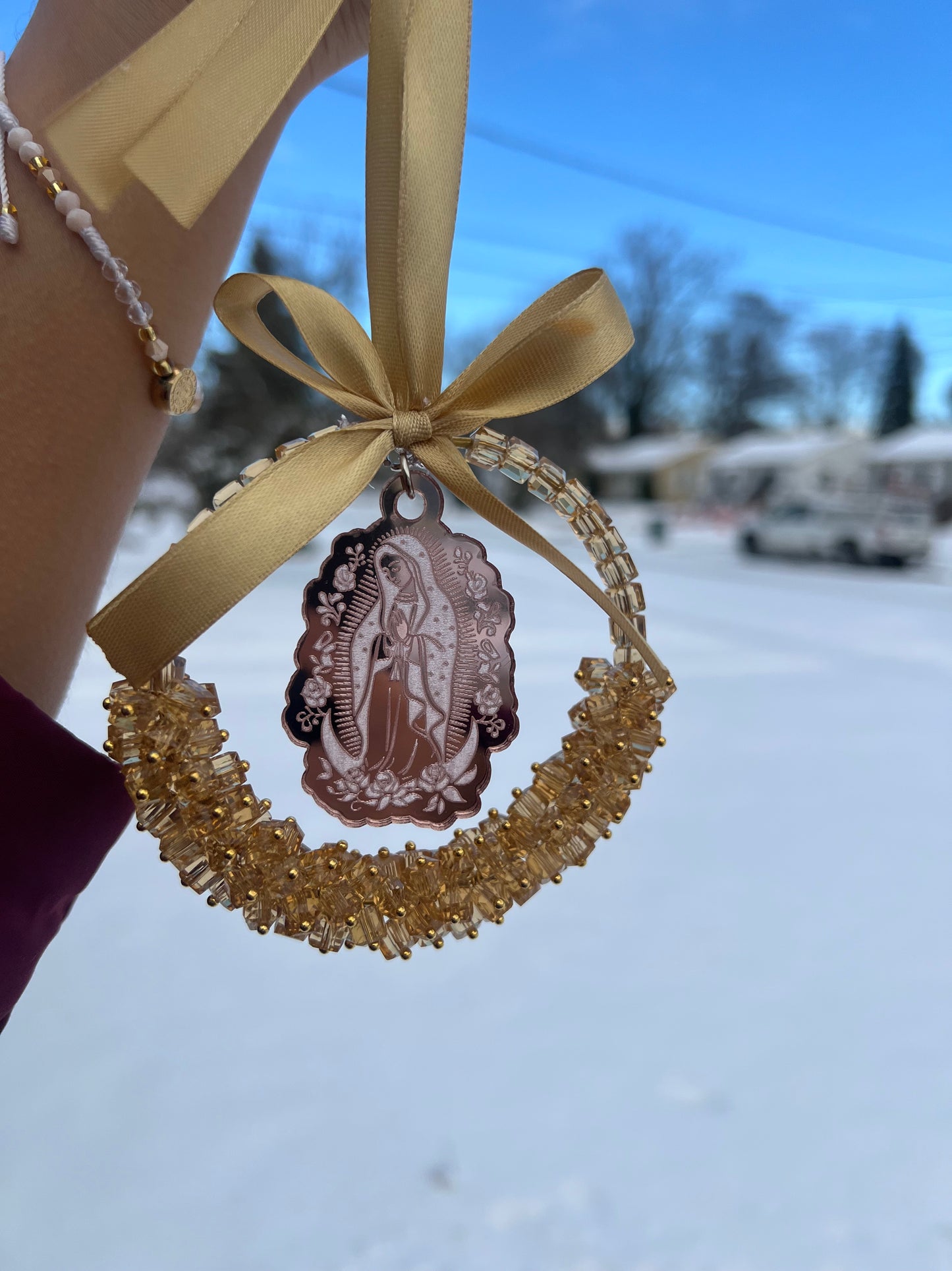 Gold car charm with pink virgencita